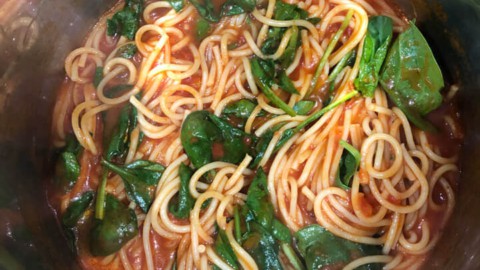 Spinach added to the cooked pasta and sauce inside the instant pot.