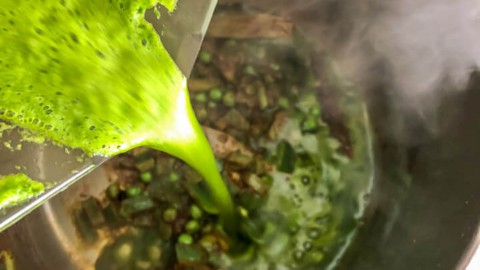 Spinach puree being poured into the inner pot.