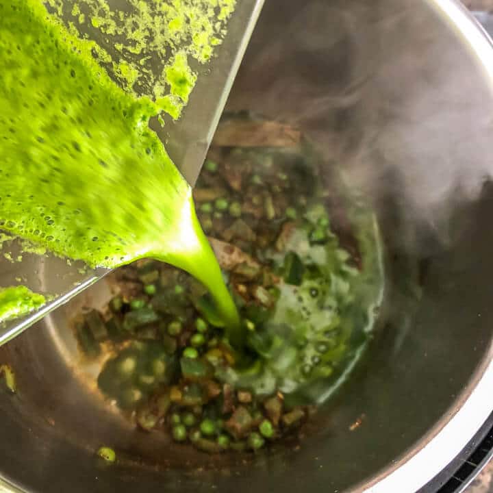 Spinach puree being poured into the inner pot.