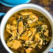 A blue handled pot with methi chicken on a wooden counter with the words Instant Pot Methi Chicken at the top.