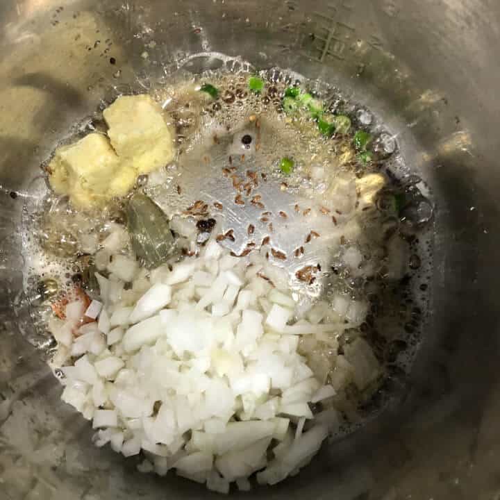 Onions and spices cooking in instant pot.
