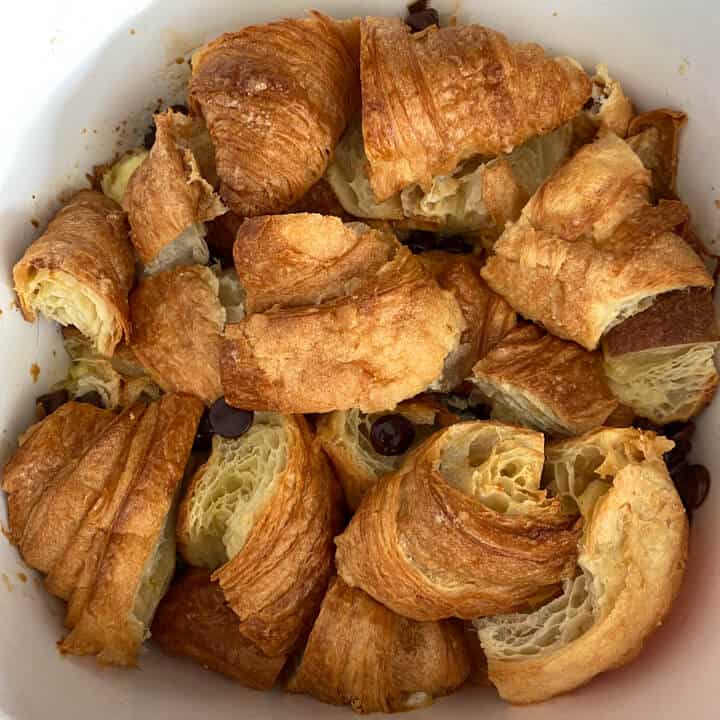A baking dish with chocolate croissant bread pudding before baking.