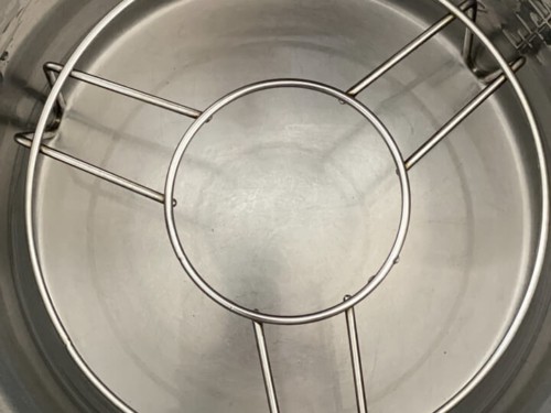 A trivet in an instant pot with water.