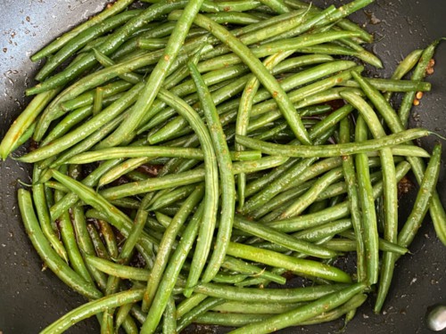 Green beans added to the skillet.