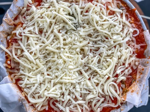 A springform pan of instant pot lasagna topped with mozzarella cheese.