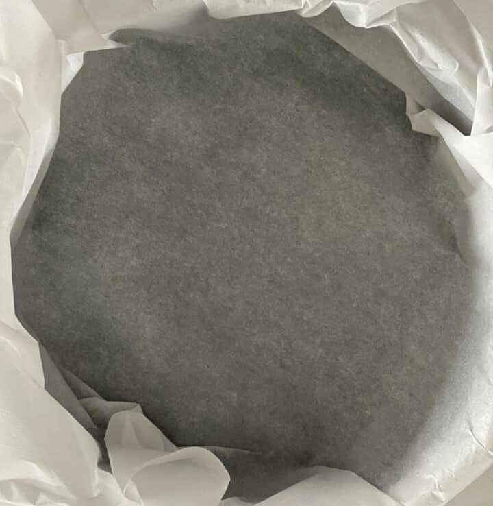 A springform pan lined with parchment paper.