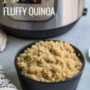 A black bowl filled to the top with fresh quinoa with a towel to the left of the bowl and an instant pot pressure cooker in the back left and the words Instant Pot Fluffy Quinoa at the top left.