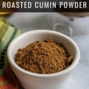 A white bowl with roasted cumin powder and the words How to Make Roasted Cumin Powder at the top.