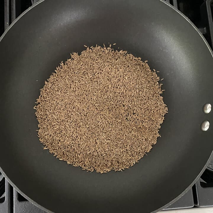 A heavy bottom pan with cumin seeds while they roast.
