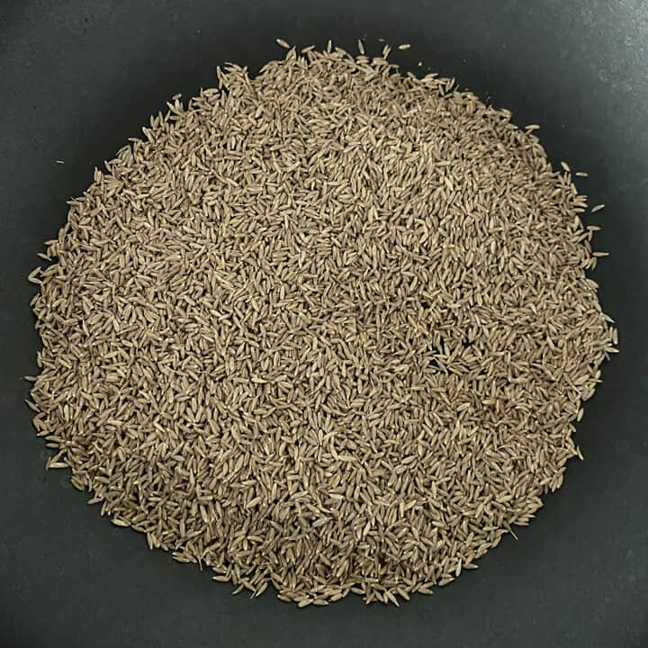 Cumin seeds in a heavy bottom pan before toasting.