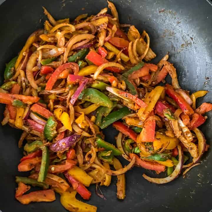 Cooked onion and peppers in the wok.
