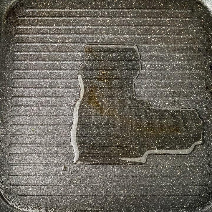Oil heated in a black grill pan