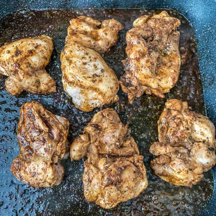 Grilled chicken on a black cutting board