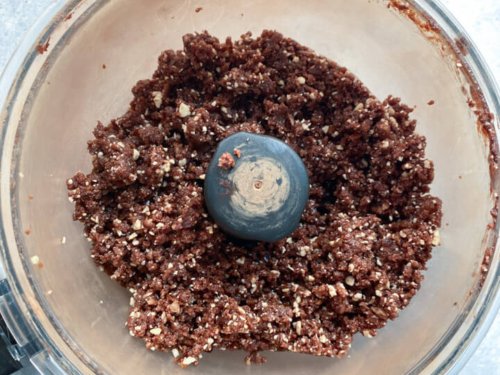 A food processor with blended energy date ball dough.