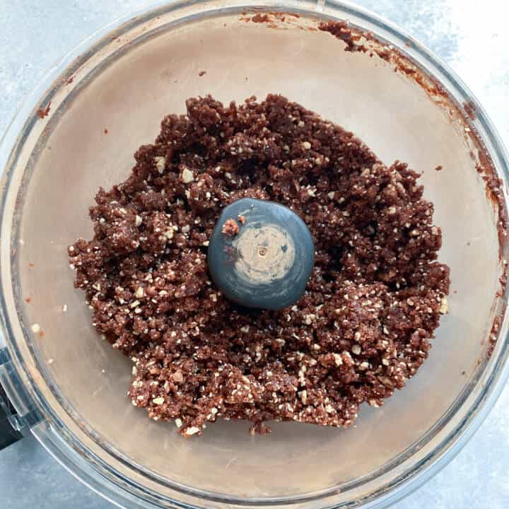 A food processor with blended energy date ball dough.