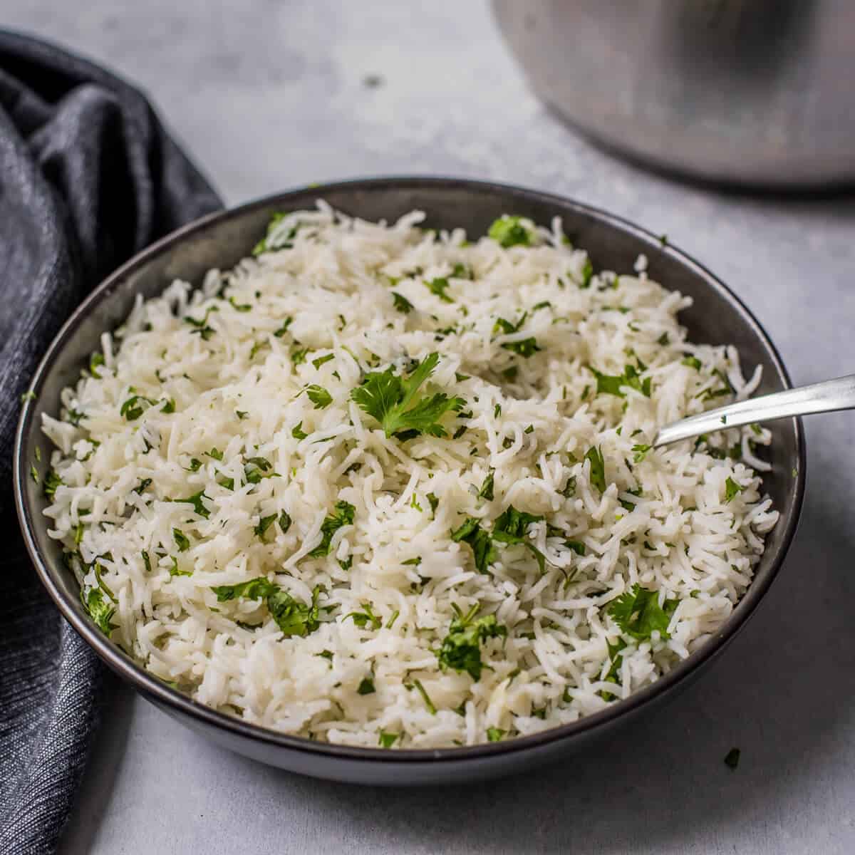 Easy cilantro lime rice in slate grey bowl with spoon