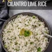 Easy cilantro lime rice served in a grey bowl with a silver spoon