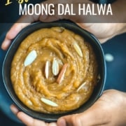 the author's hands holding a bowl of this homemade moong dal halwa recipe topped with chopped almonds