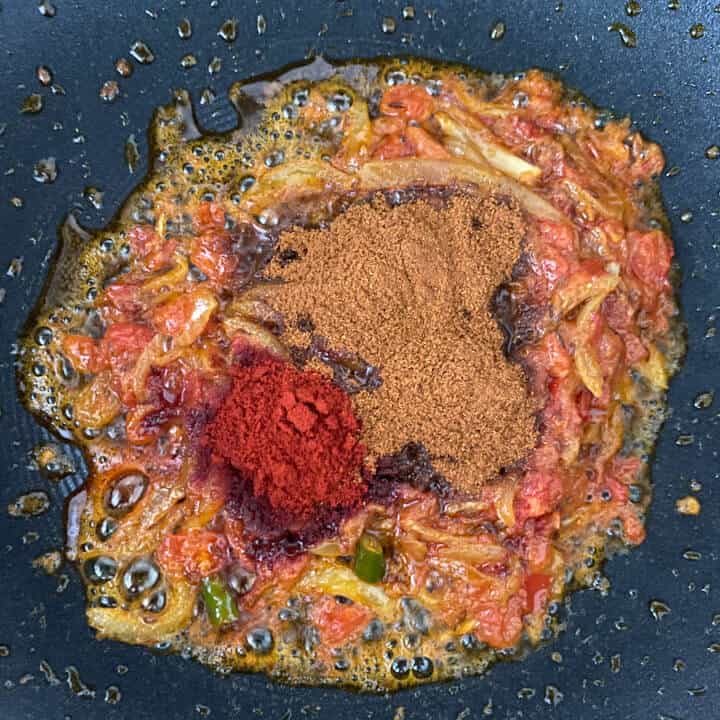 Pav bhaji masala and chili powder added to onion tomato masala