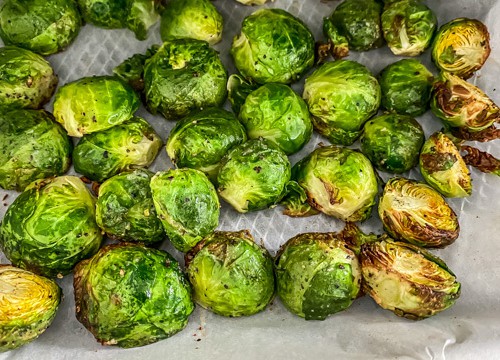 Crispy Brussels sprouts placed on parchment paper