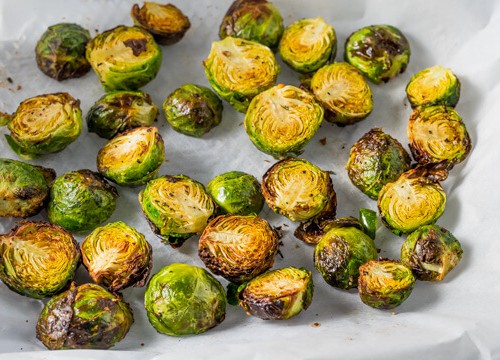 Crispy Brussels sprouts placed on parchment paper