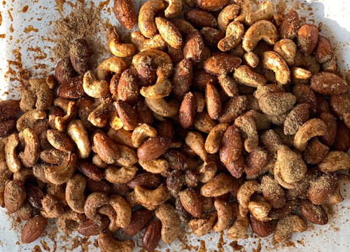 Nuts mixed with spices on parchment paper