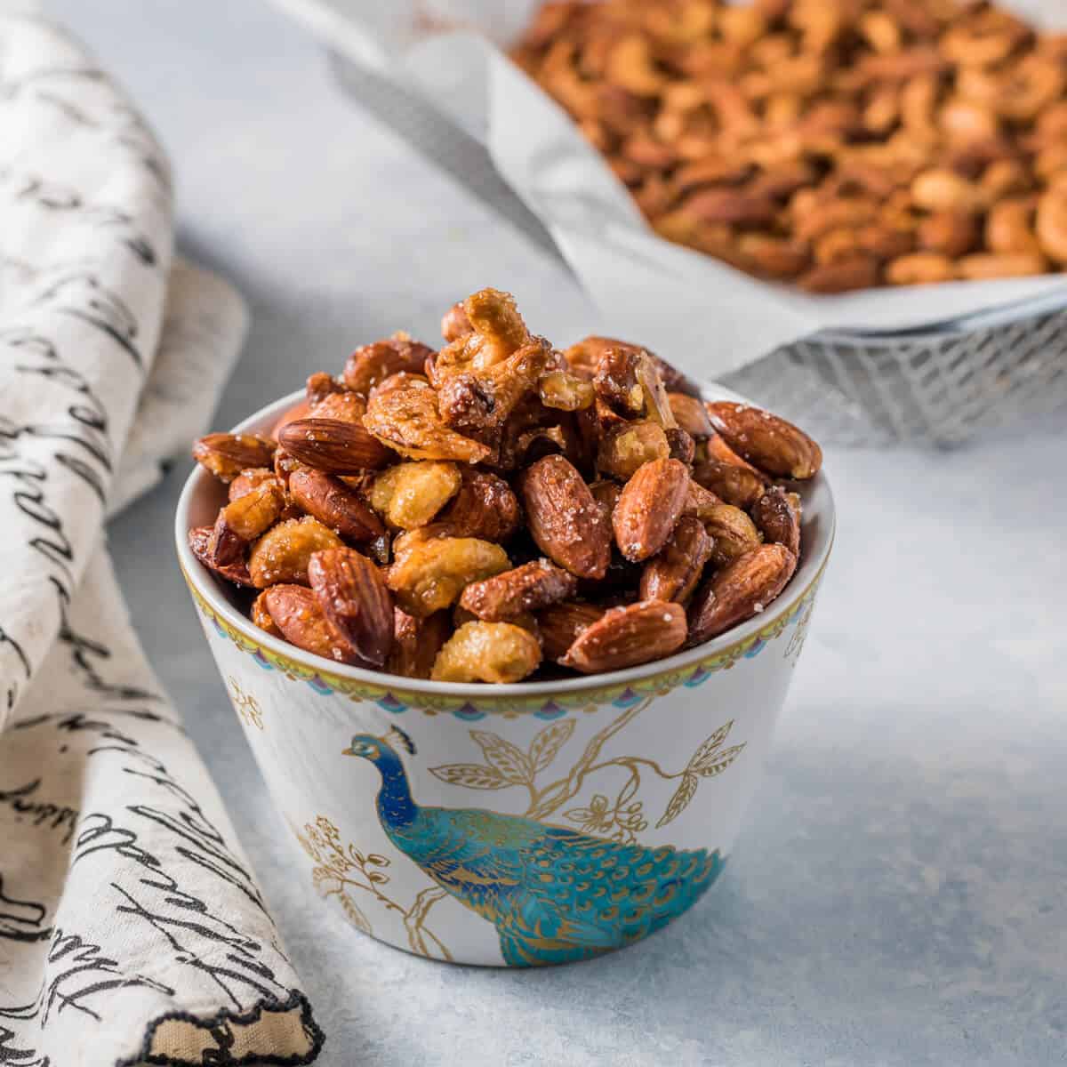 Honey roasted nuts in a bowl with a peacock in it