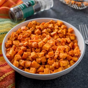 A bowl of sweet potato cubes, having just been cooked in the air fryer