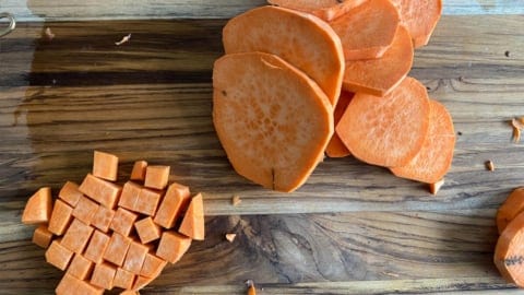 Cutting sweet potato rounds into cubes