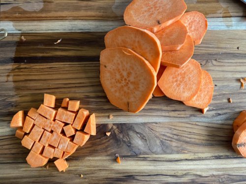 Cutting sweet potato rounds into cubes