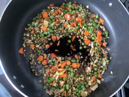 A combination of diced vegetables, sauteing in a skillet.