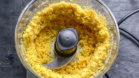 A food processor filled with ginger paste that has just been formed.