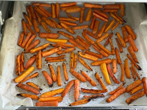 Carrot sticks that have been cooked until lightly browned.