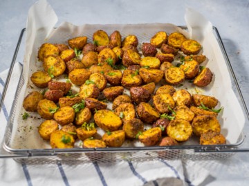 Fully cooked air fryer roasted victual potatoes, garnished with parsley.