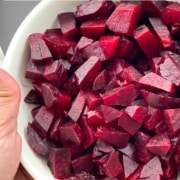 A white bowl with diced steamed beets and the words quick and easy Instant Pot Beets at the top.