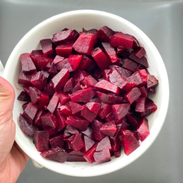 A white bowl with chopped beets after cooking in the instant pot.