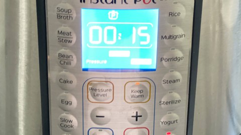 An instant pot pressure cooker with the time set to 15 minutes.