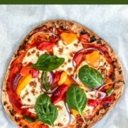 A naan pizza covered with fresh mozzarella and veggies.