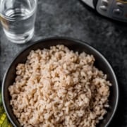 A black bowl of cooked matta rice with the words Instant Pot Kerala Matta Rice at the top.