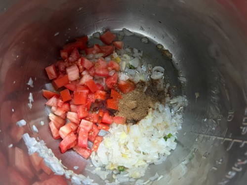 Spices and tomatoes added to the Instant Pot.