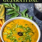 A bowl of dal topped with cilantro leaves.