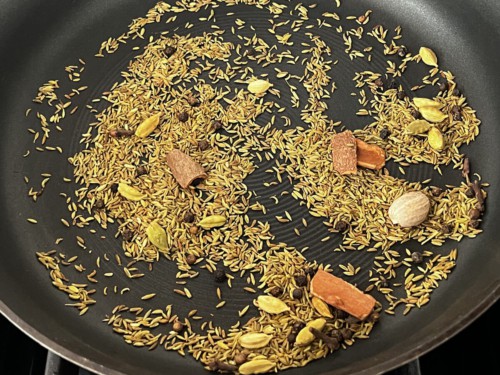 Adding spices to a skillet to toast the,
