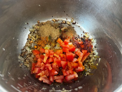 Tomatoes and spices added to the instant pot.