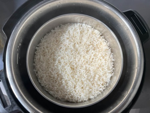 Cooked rice in a steel pot in the instant pot.