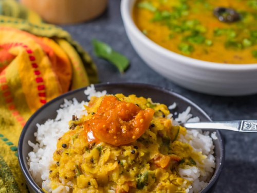 A bowl of rice topped with Gujarati Dal.