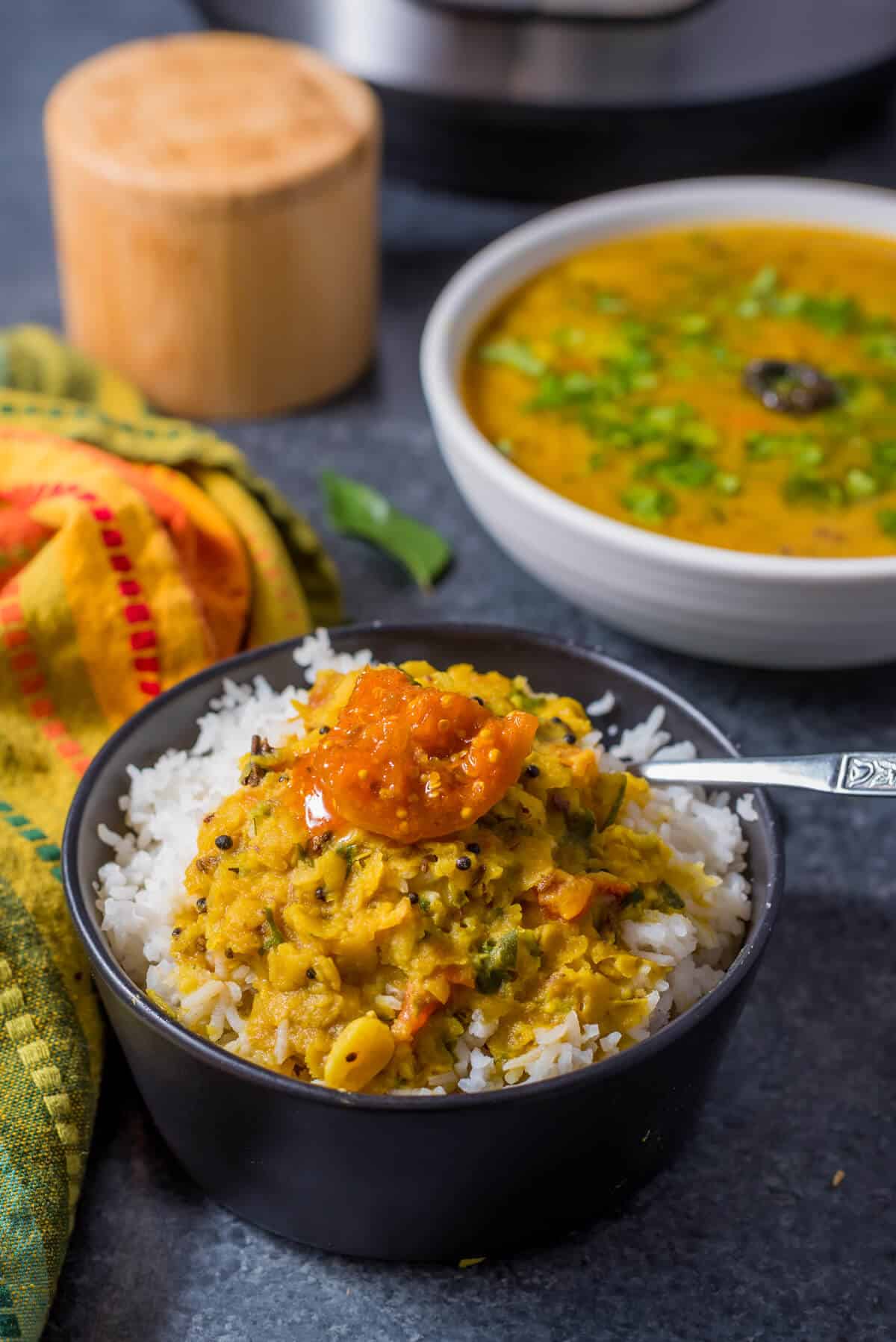 A bowl of rice topped with Gujarati Dal.