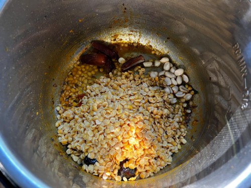 Adding rinsed dal into the insert of an Instant Pot.