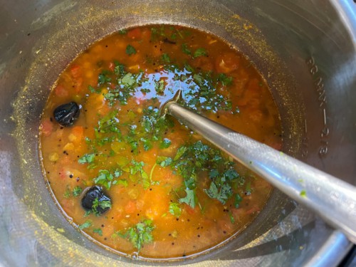 Adding jaggery, lime and cilantro to Instant Pot dal.