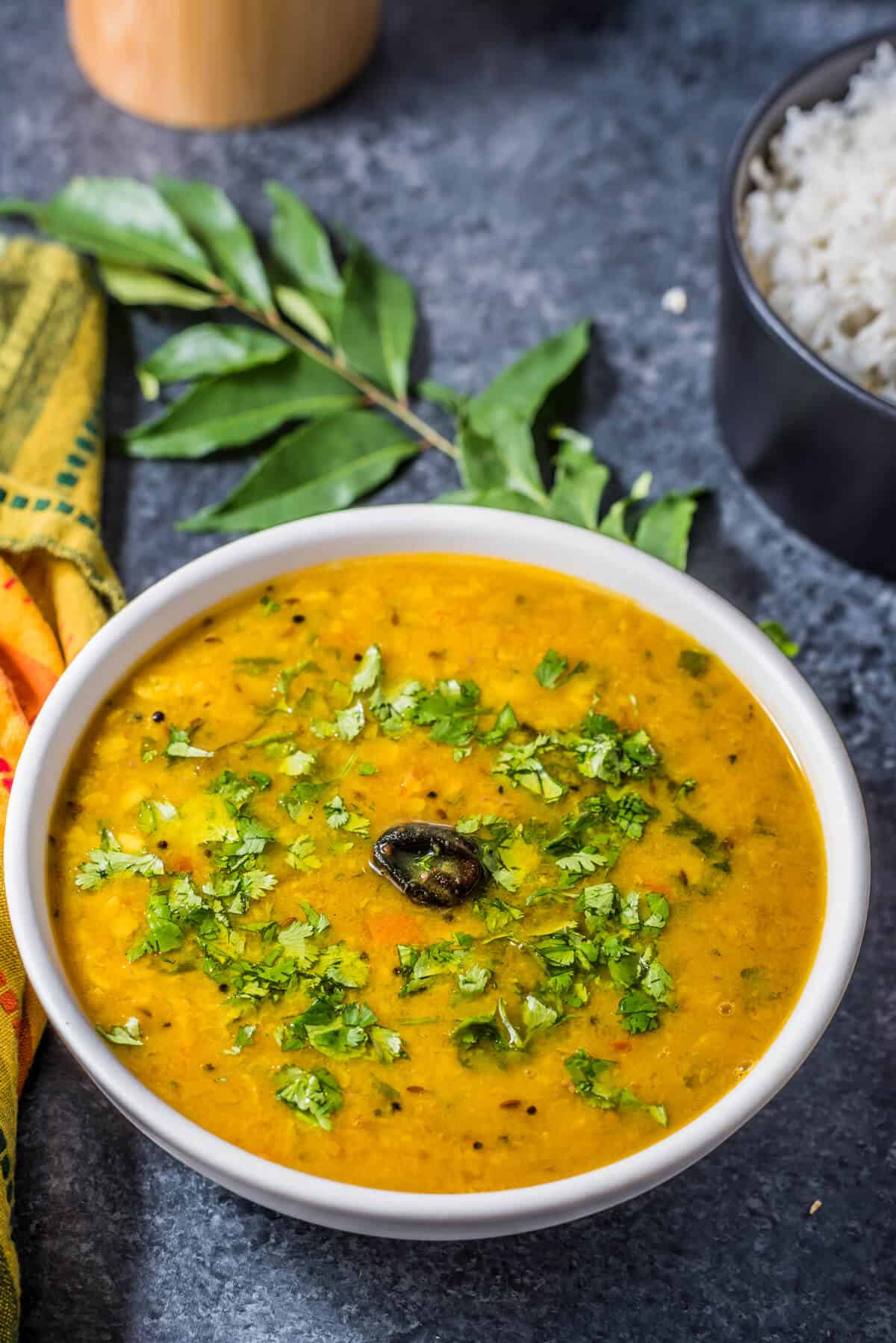 A bowl of Gujarati dal garnished with cilantro leaves.