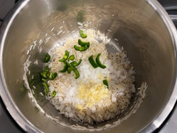 Adding jalapeños and aromatics to rice that has been sautéed in an Instant Pot.